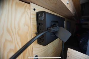 a black box with a cable plugged into a wall at Transi the Van in Düsseldorf