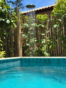 a swimming pool in front of a fence with a frisbee at Bahia Soul - Vilas de Maré - Taipu de Fora - Península de Maraú in Marau