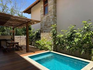 a swimming pool in the backyard of a house at Bahia Soul - Vilas de Maré - Taipu de Fora - Península de Maraú in Marau