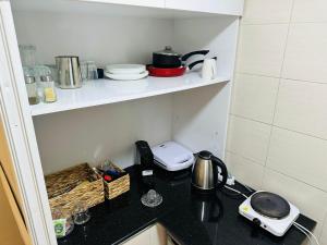 a kitchen with a counter top with appliances on shelves at charm'Studio au coeur d'Agadir in Agadir