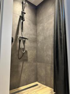 a bathroom with a shower with a shower curtain at Veldzicht in Klarenbeek +25 photos
