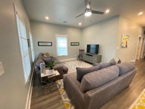 a living room with a couch and a tv at Vacation house in Galveston