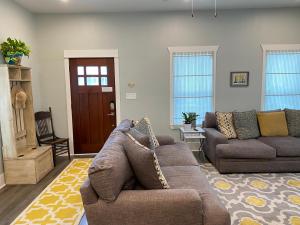 a living room with two couches and a door at Vacation house in Galveston