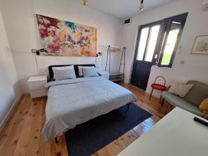 a bedroom with a large bed and a couch at Cozy City Centar Studio in Podgorica