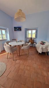a living room with a table and chairs at Pátio da Eira, Country House in Chamusca