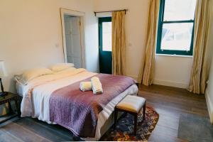 a bedroom with a bed with two towels on it at The Coach House at Ballinderry Park in Ballinasloe