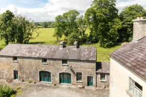 an aerial view of a stone house with a roof at The Coach House at Ballinderry Park in Ballinasloe