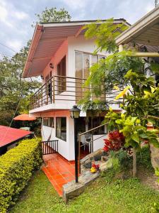 a house with a porch and a balcony at Cabaña Campestre Santa Helena in Choachí