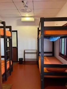a room with three bunk beds in a dorm room at One More Day Hostel, Weligama Beach in Weligama