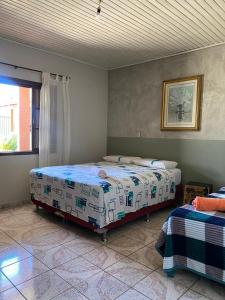 a bedroom with two beds and a window at Casa Gil in Foz do Iguaçu