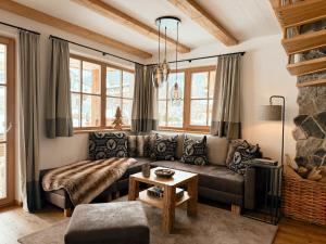 a living room with a couch and a table at Chalets Wagrain in Wagrain
