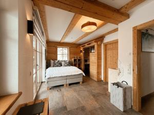 a bedroom with a bed in a room with wooden walls at Chalets Wagrain in Wagrain