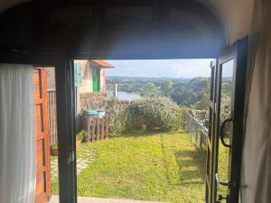 an open door to a view of a garden from a house at La Torre Guest House in Anguillara Sabazia