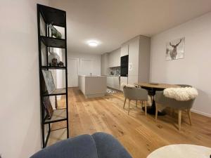 a living room and dining room with a table and chairs at Bel Appartement Centre Crans Montana, Vue Alpine et Fraîcheur in Crans-Montana +21 photos