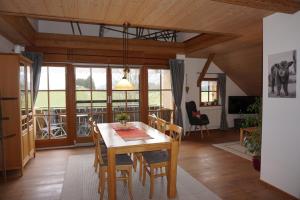 a dining room with a wooden table and chairs at Ferienhof beim Bohlar - Hochplatte in Halblech