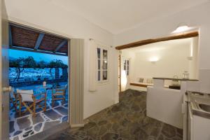 a kitchen with a view of a table and chairs at Archipelagos Apartments in Parikia