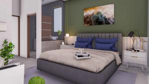 a bedroom with a large bed with blue pillows at Beach Castle Arugam Bay in Arugam Bay