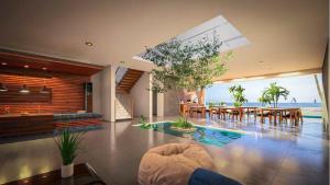 a living room with a table and chairs in a house at Beach Castle Boutique Hotel in Arugam Bay
