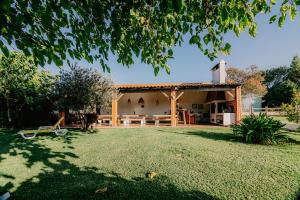 a house with a large yard in front of it at Country Club - Sto Estevao in Benavente