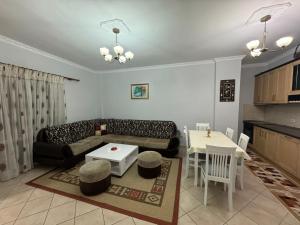 a living room with a couch and a table at Ozzy apartment in Shkodër