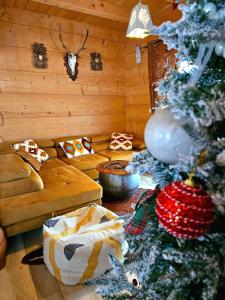 a living room with a christmas tree and a couch at Góralska Chatka 2 Highland Cottage - Split AC, Jacuzzi, Sauna, Private parking, Mountains View, Garden, Zakopane in Zakopane +73 photos
