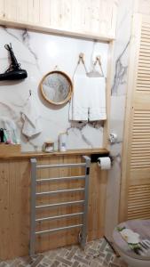 a bathroom with a sink and a mirror on a wall at Studio The Cozy Corner in Timişoara +10 photos