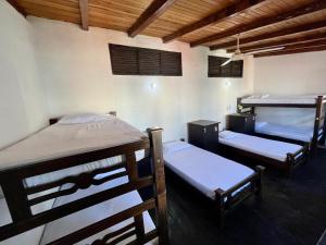 a room with three bunk beds in it at Sana Mar Hostel & Eco-Café in Santa Marta