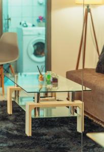 un soggiorno con tavolino in vetro e divano di Crystal Cherry Apartment a Preveza