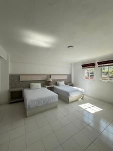 Ένα ή περισσότερα κρεβάτια σε δωμάτιο στο Alebrije Suites