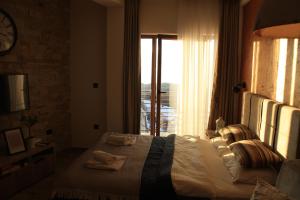 a bedroom with a large bed with a window at Silvani Kop NLux67, Milmari Apartments & Spa in Kopaonik +30 photos