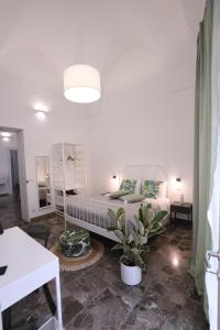 a bedroom with a bed and a potted plant at Casa Alessandra in Nardò