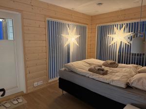 a bedroom with two large stars on the wall at Villa Golden House in Rovaniemi +51 photos