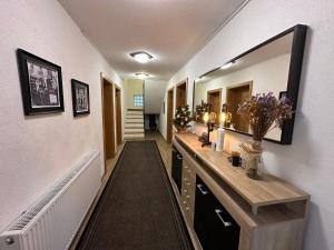 a hallway with a vanity and a mirror on a wall at Apartman - Sobe Tiha Luka, Bjelašnica in Bjelašnica