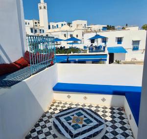 a balcony with a view of a pool and buildings at Dreaming Rooms - Sidi Bou Saïd in Sidi Bou Saïd
