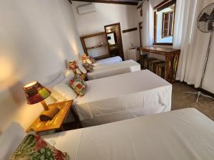 Cama ou camas em um quarto em Casa de Paixão Caraíva