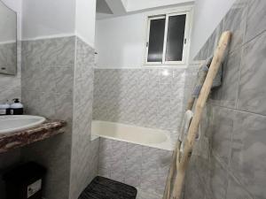 a bathroom with a bath tub and a sink at Appartement de luxe 155m agdal centre in Rabat +56 photos