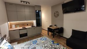 a room with a bed and a kitchen with a table at One-room apartment Nyska Residence Free garage!!! in Wrocław