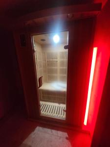 a small room with a red light in a red room at La chambres des tentations in Grignan
