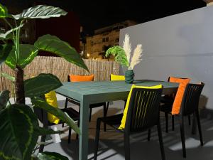 a green table and chairs with plants on a patio at Appartement de luxe 155m agdal centre in Rabat