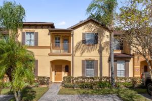 a house with palm trees in front of it at Lazy River Resort Townhome in Davenport
