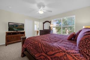 a bedroom with a bed and a flat screen tv at Lazy River Resort Townhome in Davenport +35 photos