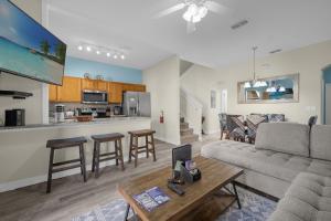 a living room and kitchen with a couch and a table at Lazy River Resort Townhome in Davenport