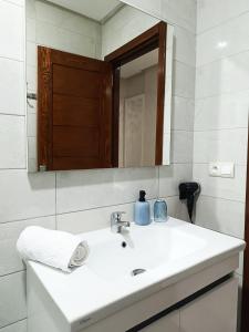 a bathroom with a white sink and a mirror at La Jolie Al Jadid in Nador +31 photos