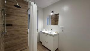 a white bathroom with a sink and a shower at Campus Biebrza - apartamenty biebrzańskie in Osowiec +23 photos