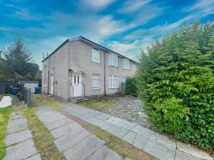 a large brick building with a sidewalk in front of it at Spectacular Modern Glasgow Home Luxury King Bed in Glasgow