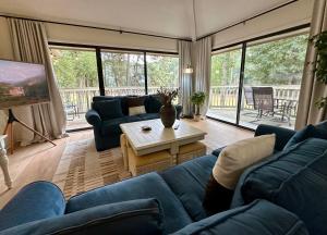 un salon avec un canapé bleu et une table dans l'établissement Golf/ Beach Penthouse Condo, à Sunset Beach