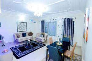 a living room with a couch and a table at Résidence Le Prestige in Yaoundé