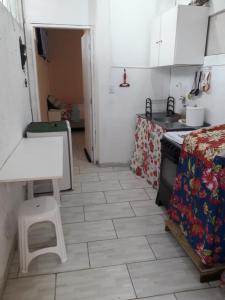 a kitchen with a table and a stove and a floor at Studio Dunas Porto Lagoa in Florianópolis +8 photos