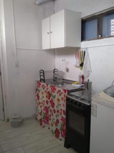 a kitchen with a sink and a stove top oven at Studio Dunas Porto Lagoa in Florianópolis