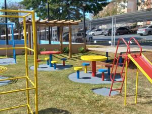 a playground with colorful tables and a slide at Mi casa su casa 4 in Londrina